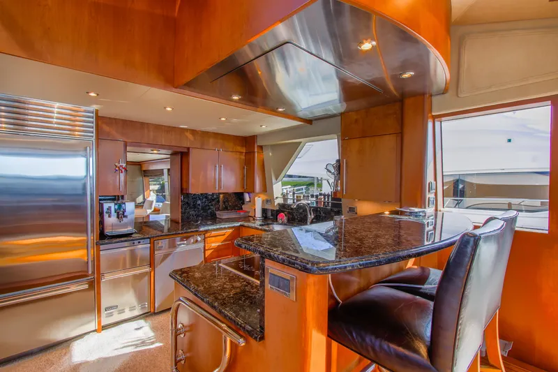 Slide: The Image of 2006 Northcoast Yachts Yachtfisher on water, featuring sleek design and covered deck. - 41