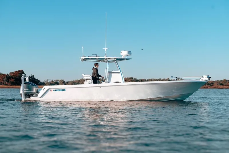 The Image of 2020 Contender 32 ST boat cruising on calm water under clear blue sky. - 0