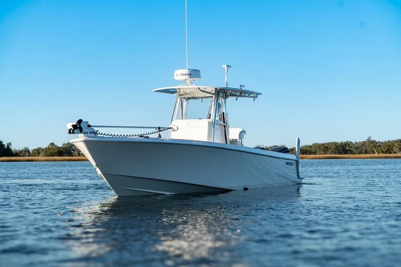 Slide: The Image of 2020 Contender 32 ST boat on calm water under clear blue sky. - 1