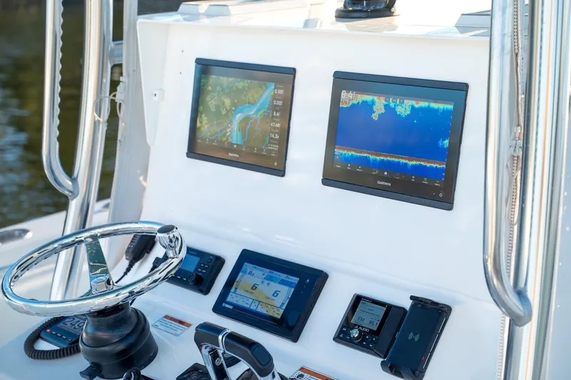 Slide: The Image of 2020 Contender 32 ST boat dashboard with Garmin navigation displays and controls. - 10