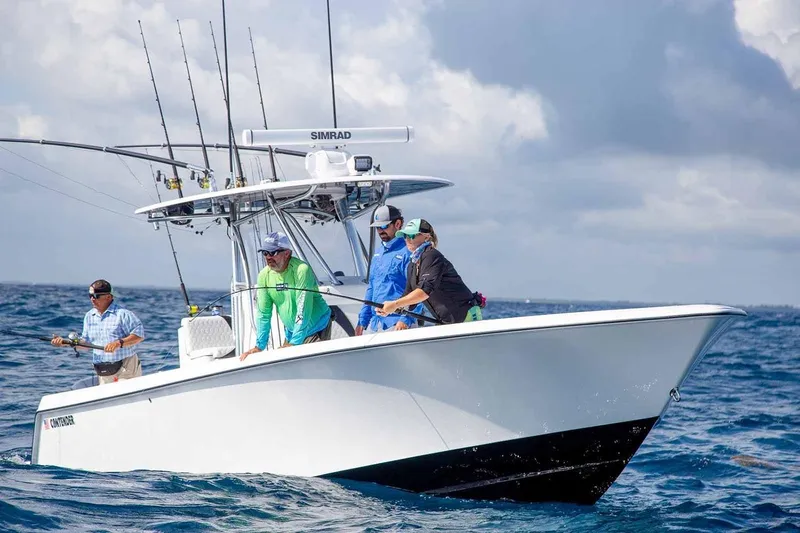 Slide: The Image of Manufacturer Provided Image: 2020 Contender 32 ST fishing boat with anglers on open water. - 104