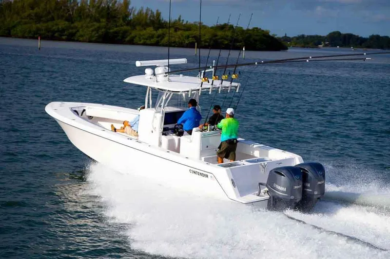 Slide: The Image of Manufacturer Provided Image: 2020 Contender 32 ST boat cruising on water with fishing rods. - 105