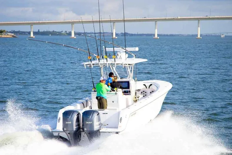Slide: The Image of Manufacturer Provided Image: 2020 Contender 32 ST boat cruising on the water with fishing rods. - 106