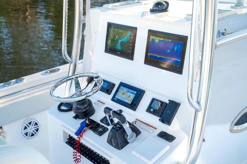 Slide: The Image of 2020 Contender 32 ST boat dashboard with advanced navigation and control systems. - 12