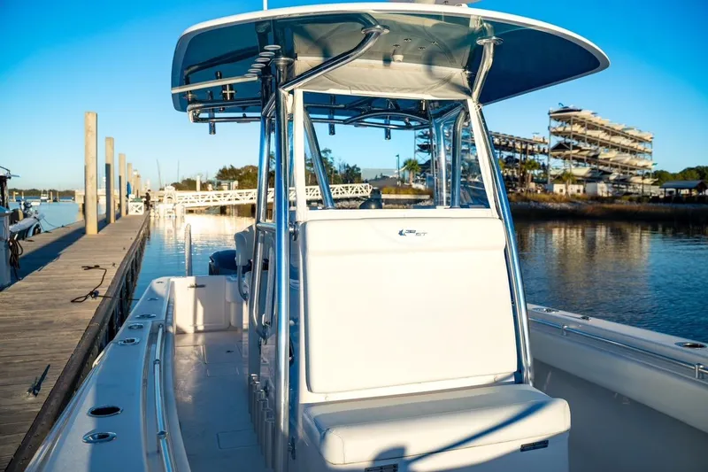 Slide: The Image of 2020 Contender 32 ST boat docked at marina under clear blue sky. - 16