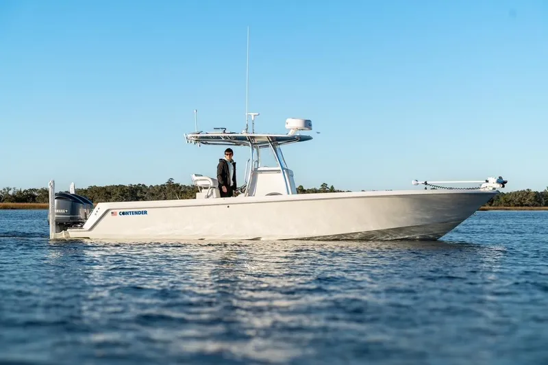 Slide: The Image of 2020 Contender 32 ST boat on calm water, clear sky background. - 2