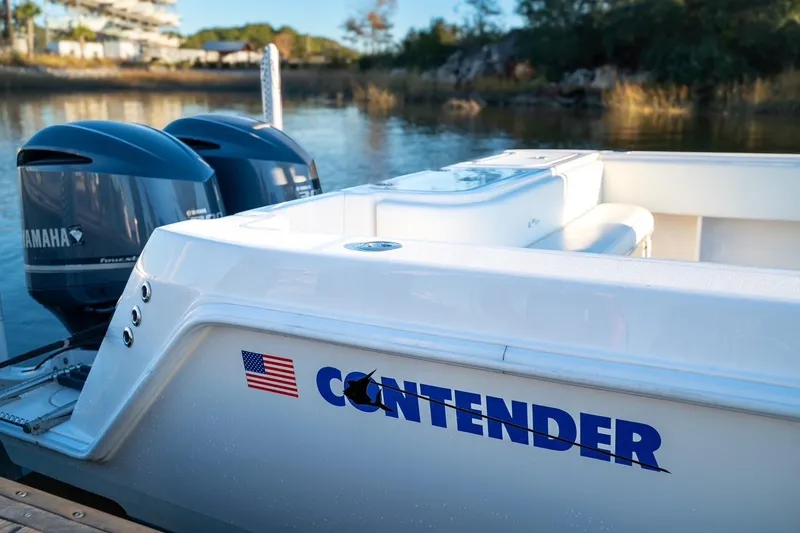 Slide: The Image of 2020 Contender 32 ST boat with Yamaha engines docked by the water. - 20