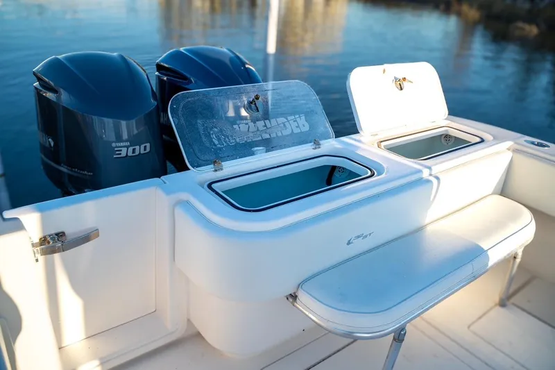Slide: The Image of 2020 Contender 32 ST boat with Yamaha 300 engines, featuring open storage compartments. - 24