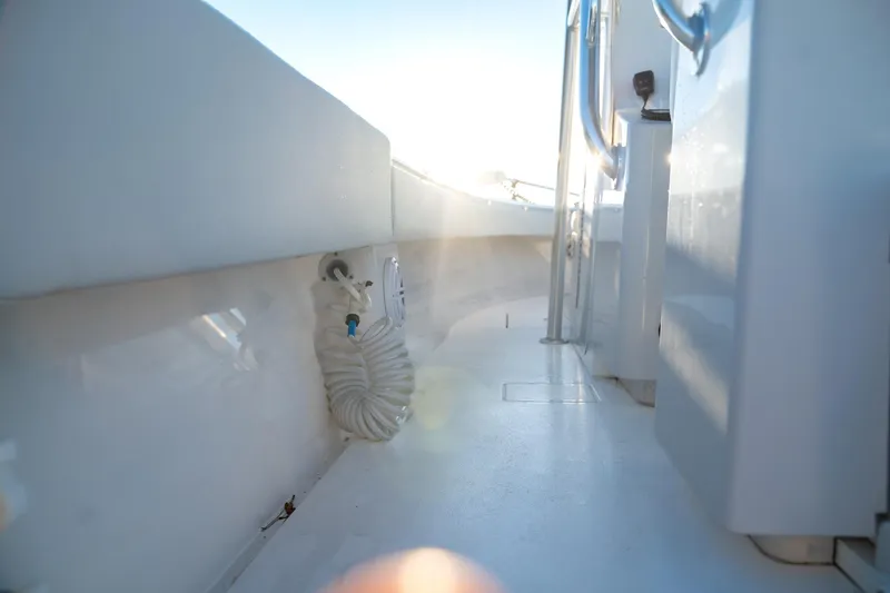 Slide: The Image of 2020 Contender 32 ST boat interior with coiled hose and sunlight. - 29