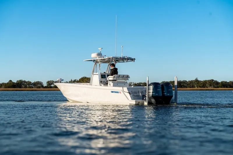 Slide: The Image of 2020 Contender 32 ST boat on calm water under clear blue sky. - 3