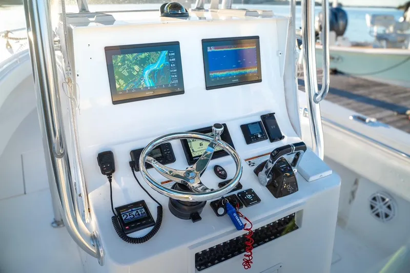 Slide: The Image of Center console of a 2020 Contender 32 ST boat with navigation screens and controls. - 30