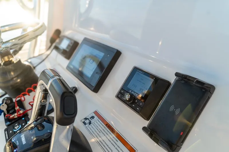 Slide: The Image of 2020 Contender 32 ST boat dashboard with modern controls and navigation displays. - 31