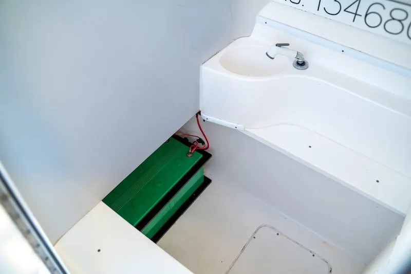 Slide: The Image of 2020 Contender 32 ST boat interior with sink and green battery. - 36