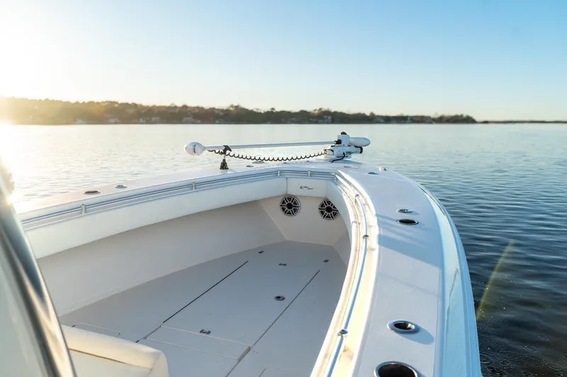 Slide: The Image of 2020 Contender 32 ST boat on calm water at sunrise, showcasing sleek design. - 39