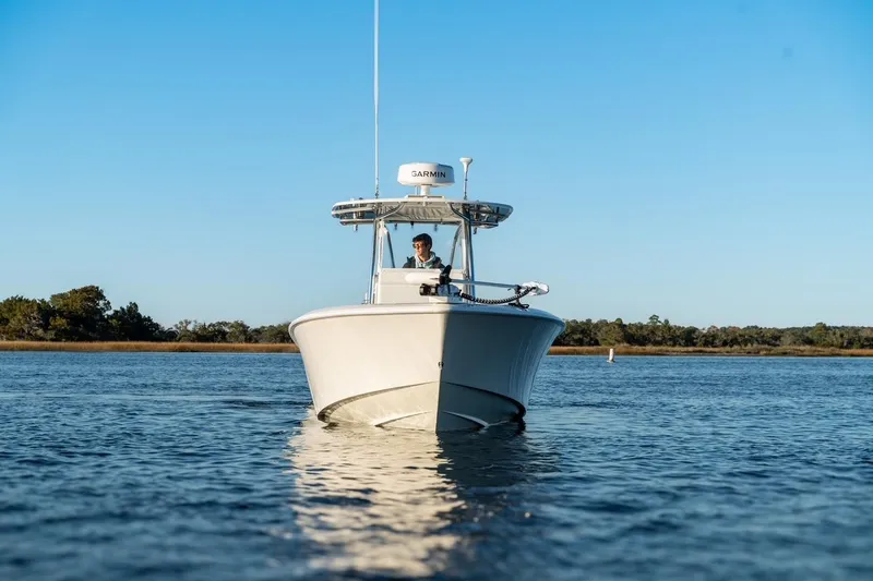 Slide: The Image of 2020 Contender 32 ST boat cruising on calm water under clear blue sky. - 4