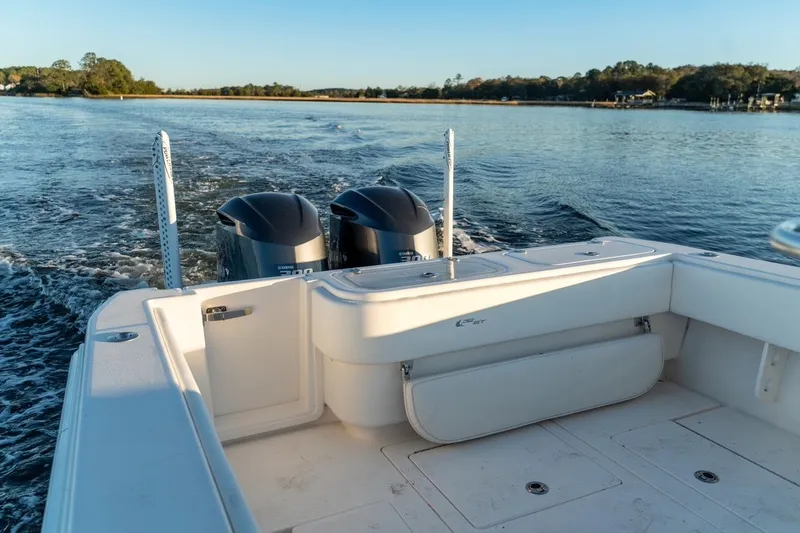 Slide: The Image of 2020 Contender 32 ST boat with dual engines cruising on a calm lake. - 40