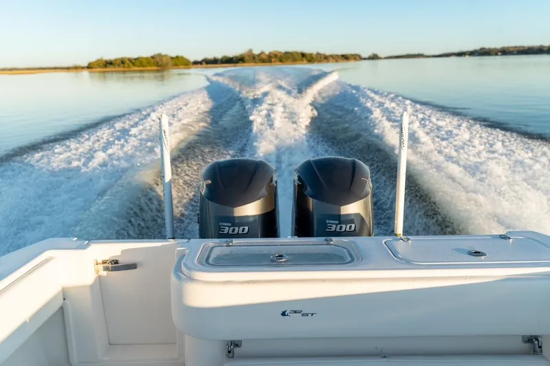Slide: The Image of 2020 Contender 32 ST boat with dual Yamaha 300 engines cruising on calm water. - 41