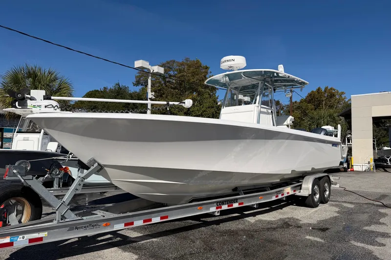 Slide: The Image of 2020 Contender 32 ST boat on trailer, parked outdoors under clear blue sky. - 43