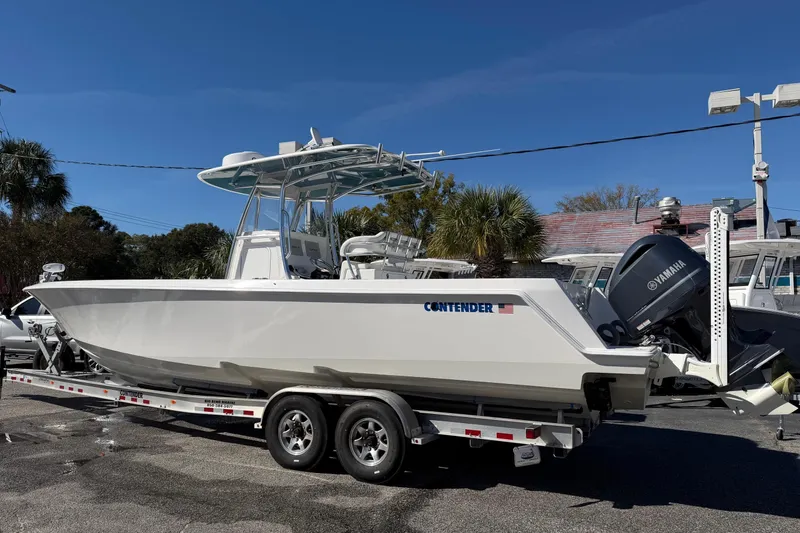 Slide: The Image of 2020 Contender 32 ST boat on trailer with Yamaha outboard motor, parked outdoors. - 45