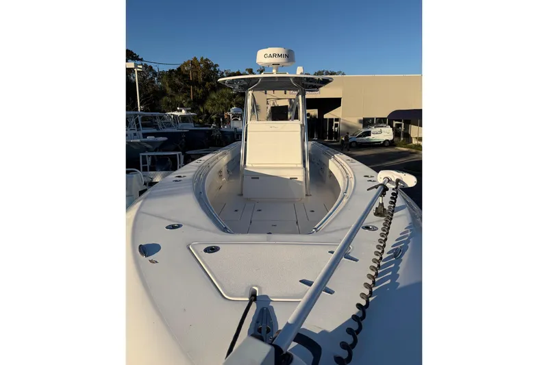 Slide: The Image of 2020 Contender 32 ST boat with Garmin equipment, docked under clear blue sky. - 46