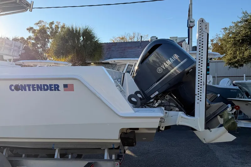 Slide: The Image of 2020 Contender 32 ST boat with Yamaha outboard motor, parked outdoors. - 48