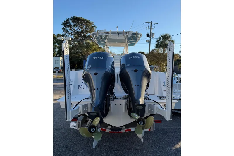 Slide: The Image of 2020 Contender 32 ST boat with dual 300 horsepower outboard engines, rear view. - 49