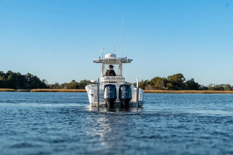 Slide: The Image of 2020 Contender 32 ST boat cruising on calm water with clear blue sky. - 5