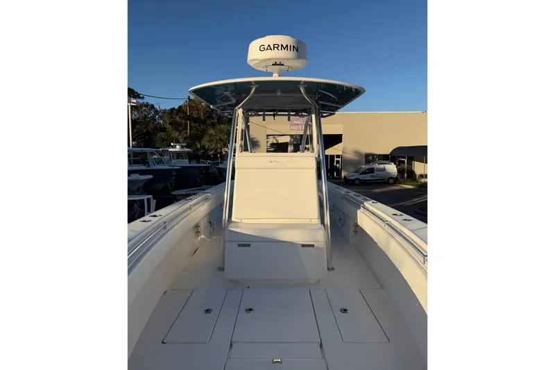 Slide: The Image of 2020 Contender 32 ST boat with Garmin radar, docked under clear blue sky. - 58