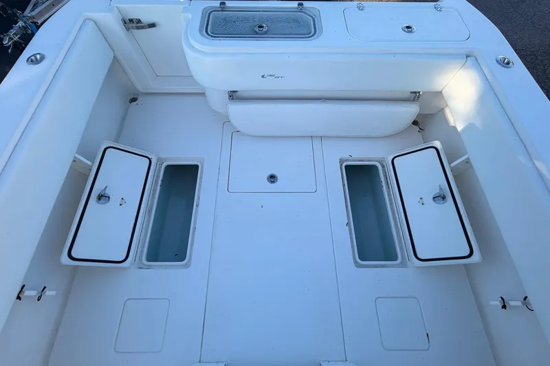Slide: The Image of 2020 Contender 32 ST boat deck with open storage compartments and seating. - 61