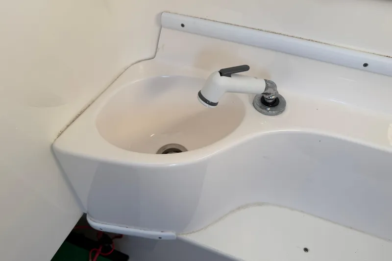 Slide: The Image of Compact sink with faucet in 2020 Contender 32 ST boat interior. - 65