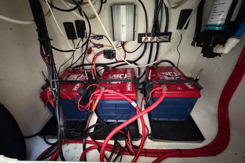 Slide: The Image of Battery compartment of a 2020 Contender 32 ST boat with wiring and connections. - 67