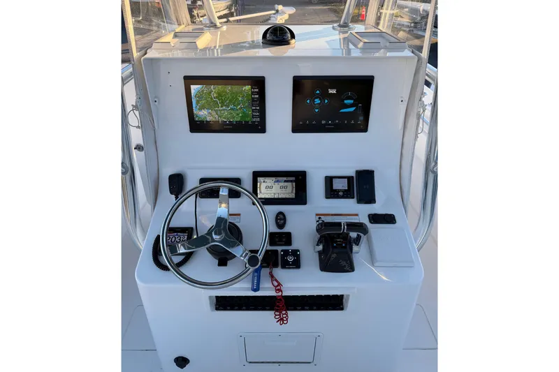 Slide: The Image of 2020 Contender 32 ST boat dashboard with navigation screens and controls. - 71