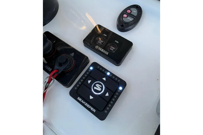 Slide: The Image of Control panel of a 2020 Contender 32 ST boat with Seakeeper and Yamaha controls. - 72