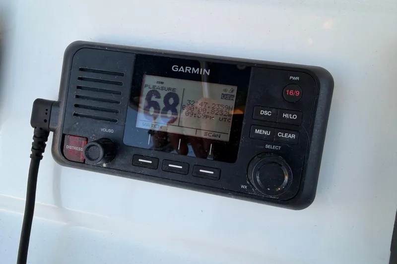 Slide: The Image of Garmin marine radio on 2020 Contender 32 ST boat dashboard. - 78