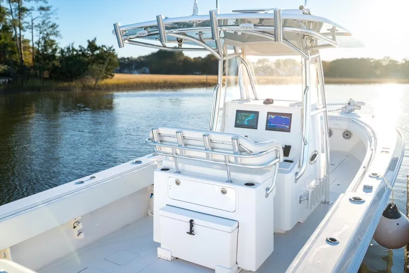 Slide: The Image of 2020 Contender 32 ST boat with dual screens, sleek design, and scenic water backdrop. - 8