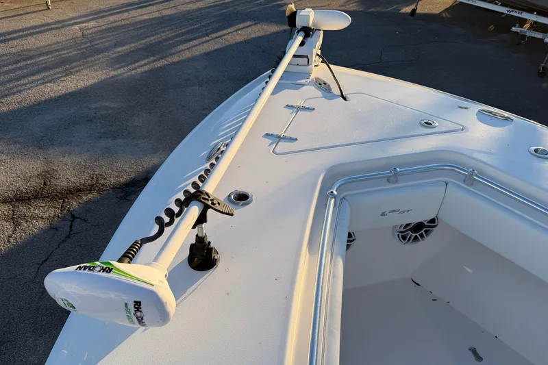 Slide: The Image of 2020 Contender 32 ST boat with trolling motor on deck, docked in sunlight. - 82