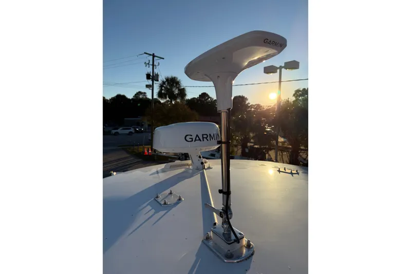 Slide: The Image of Garmin antennas on 2020 Contender 32 ST boat at sunset, highlighting marine technology. - 88