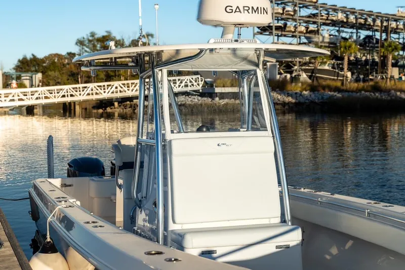 Slide: The Image of 2020 Contender 32 ST boat docked, featuring Garmin equipment, calm water background. - 9