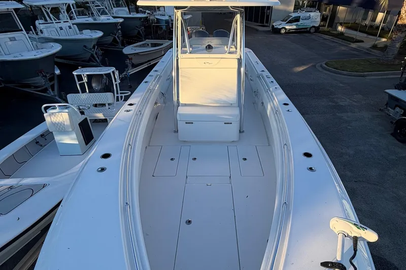 Slide: The Image of 2020 Contender 32 ST boat, white deck, center console, parked among other boats. - 91