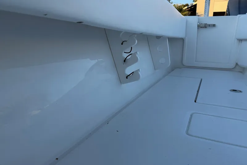 Slide: The Image of 2020 Contender 32 ST boat interior with rod holders and storage compartments. - 94
