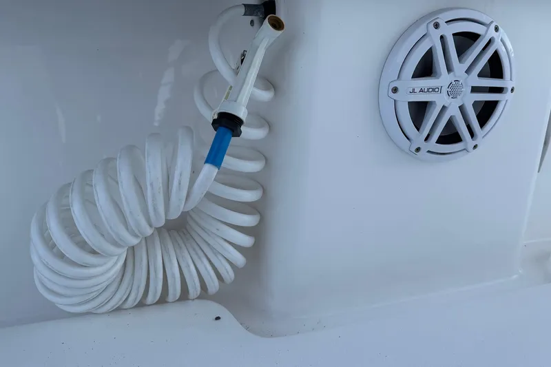 Slide: The Image of Coiled hose and JL Audio speaker on 2020 Contender 32 ST boat. - 95