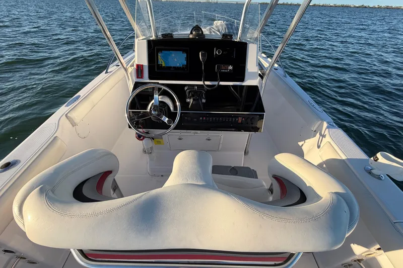 Slide: The Image of 1999 Donzi 35 ZF Cuddy boat cockpit with steering wheel and navigation system. - 16