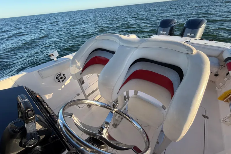 Slide: The Image of 1999 Donzi 35 ZF Cuddy boat interior with dual seats and ocean view. - 18