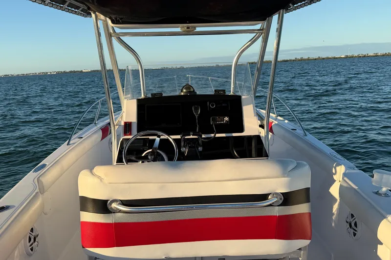 Slide: The Image of 1999 Donzi 35 ZF Cuddy boat interior with steering wheel, dashboard, and ocean view. - 19