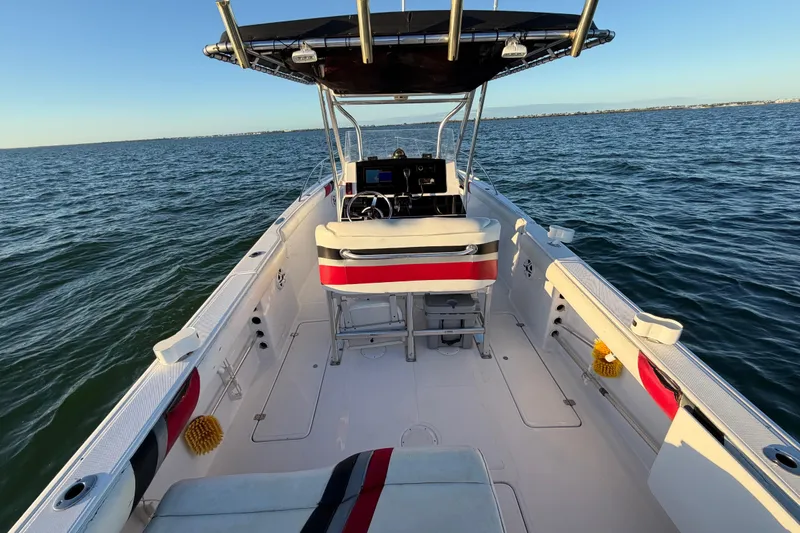 Slide: The Image of 1999 Donzi 35 ZF Cuddy boat interior on open water, featuring helm and seating. - 20