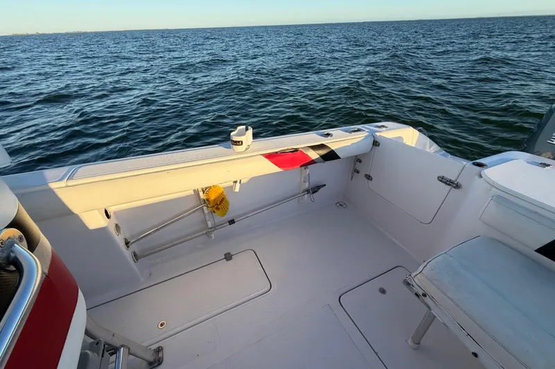 Slide: The Image of 1999 Donzi 35 ZF Cuddy boat interior with ocean view, featuring white seating and deck. - 22