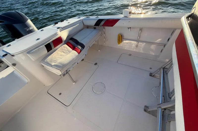 Slide: The Image of 1999 Donzi 35 ZF Cuddy boat interior with seating, Yamaha 300 engine, and ocean view. - 24