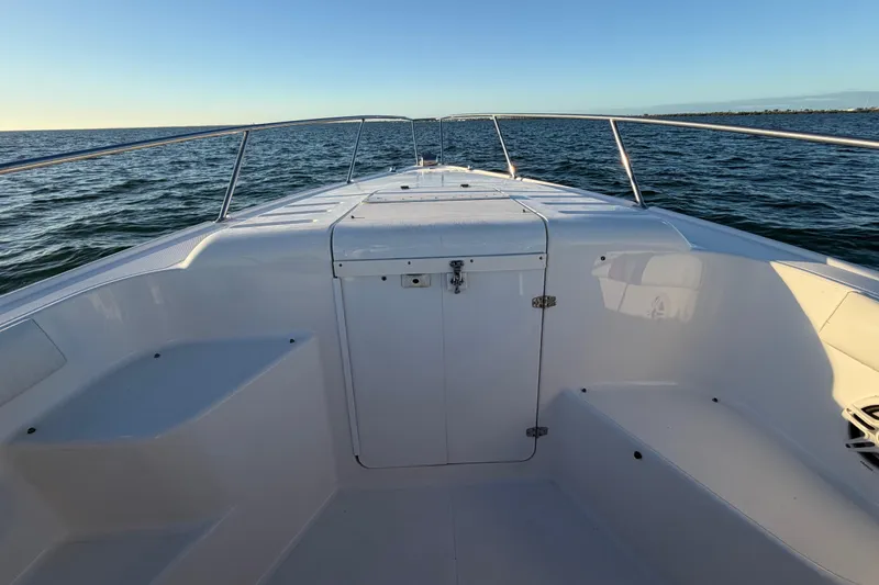 Slide: The Image of 1999 Donzi 35 ZF Cuddy boat on open water, showcasing spacious deck and sleek design. - 27