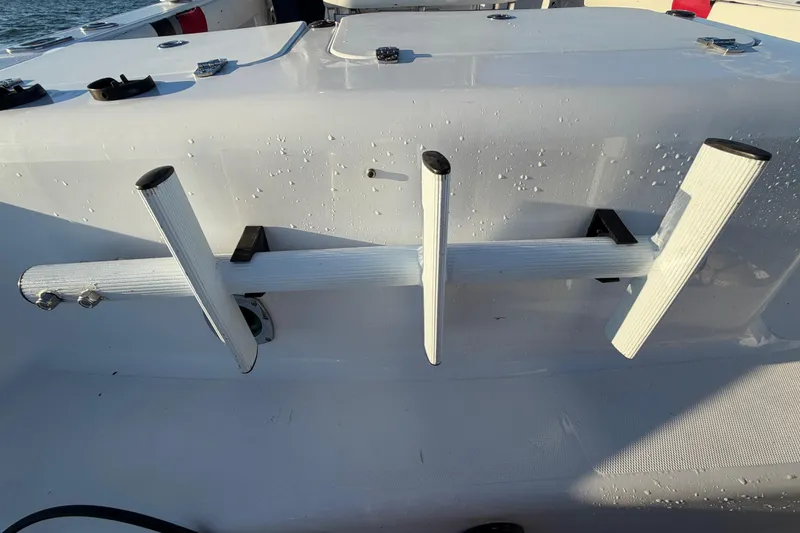 Slide: The Image of Rod holders on a 1999 Donzi 35 ZF Cuddy boat, wet with water droplets. - 31
