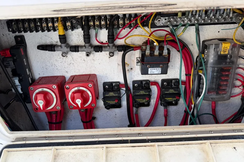 Slide: The Image of Electrical panel of a 1999 Donzi 35 ZF Cuddy boat with wiring and switches. - 33